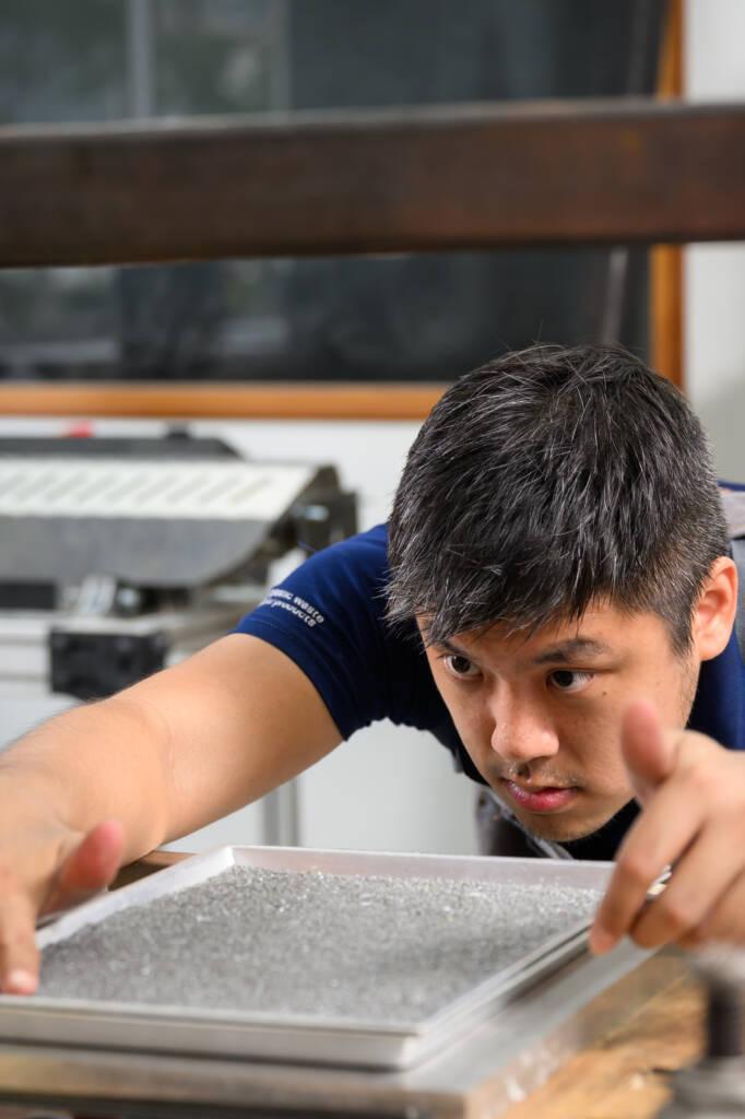 Semula Asia founder recycling with precision measurement of a recycled plastic component.