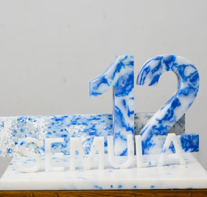 Sustainable 3D alphabet letter blocks handcrafted from vibrant, multi-colored recycled plastic for eco-conscious home decor.