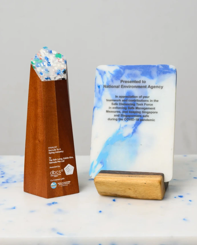 Eco-friendly corporate plaque with a unique marbled recycled plastic finish and polished metal engraving by Semula Asia.